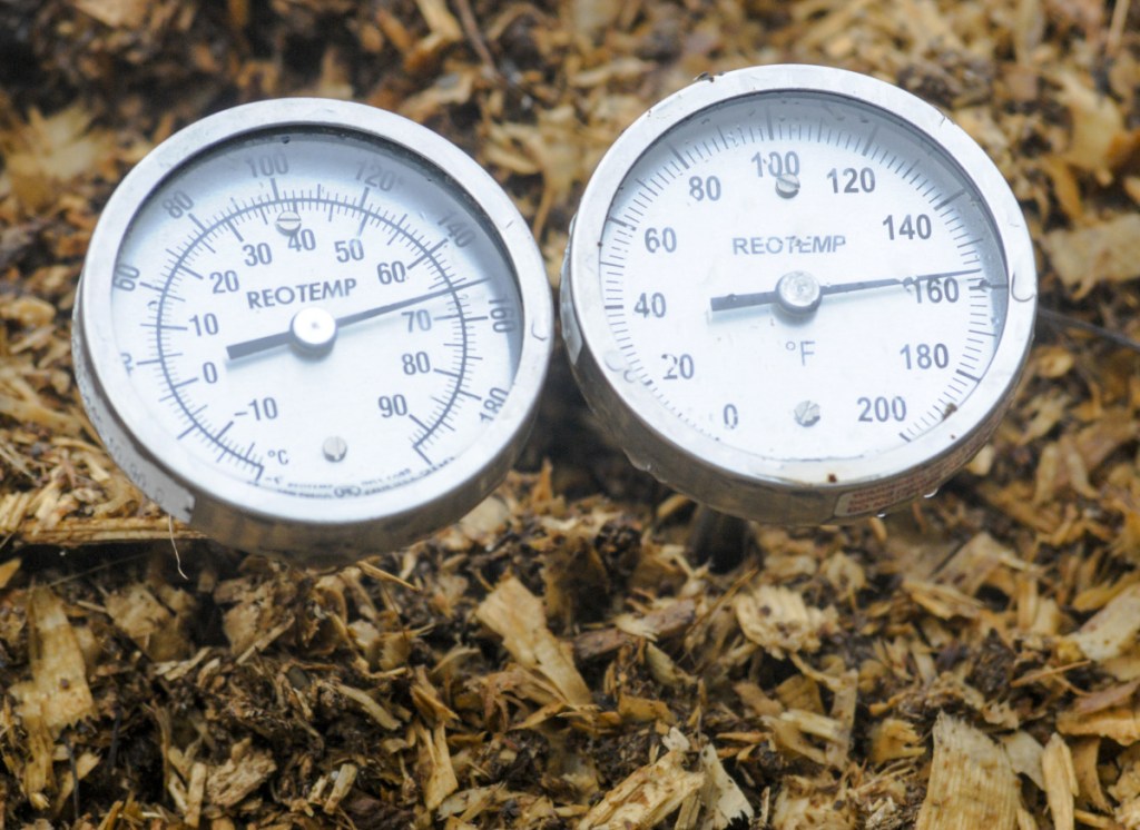 Thermometers, with different length probes, measure temperature on the edge and in the middle of compost piles Wednesday at Highmoor Farm in Monmouth.