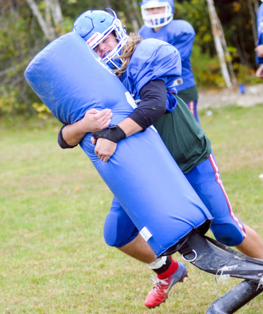 Oak Hill linebacker Ethan Richard wraps up a bag during practice Wednesday in Wales.