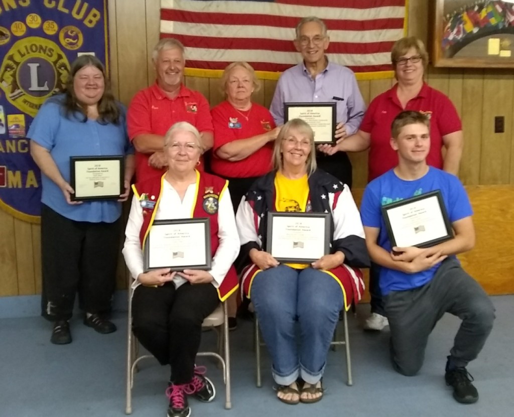 The Manchester Lions recently presented its Spirit of America award, from left are Linda Cobb, Carolyn Van Horn and John Lauter. In back, from left, are Ruth Short, Manchester Spirit of America organizer and emcee David Worthing, Arlene Gagnon, Leon Strout and Debbie Maddox.