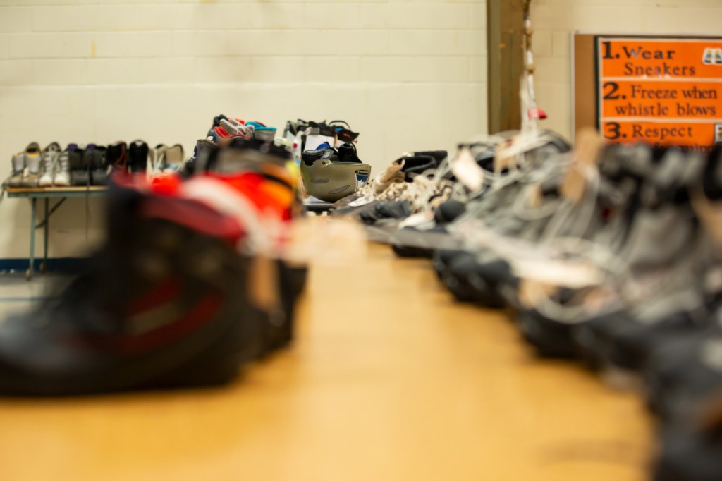 Tables are covered with hockey, alpine skiing and Nordic skiing equipment as part of the Central Maine Ski-Skate Swap on Saturday at the George G. Mitchell School in Waterville.