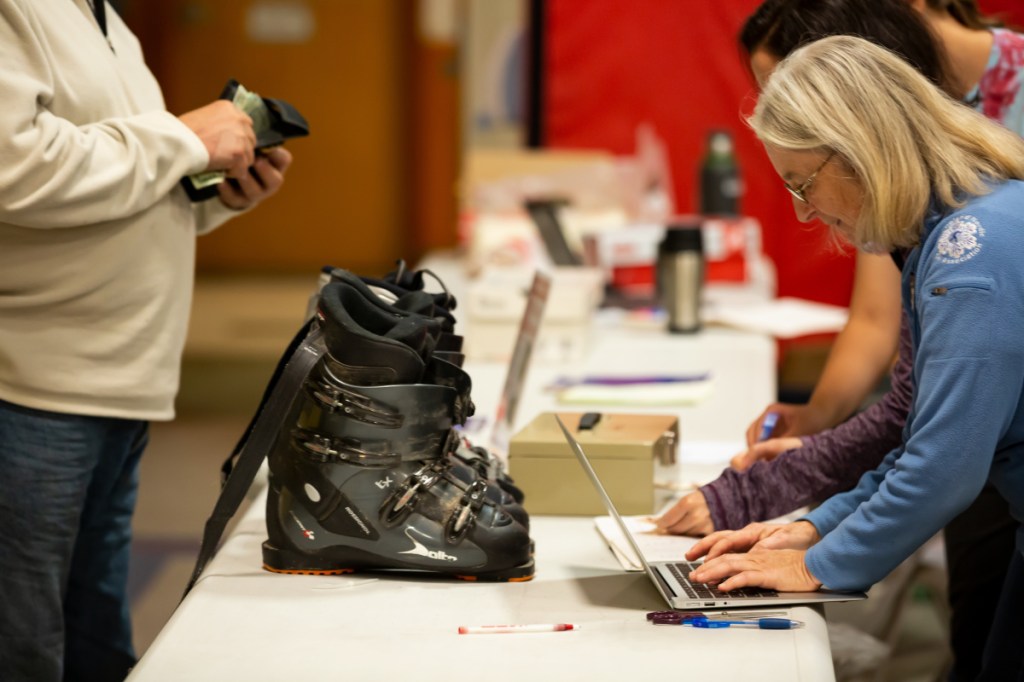 Caroline Mathes enters a sale at the Central Maine Ski-Skate Swap on Saturday at the George G. Mitchell School in Waterville. The Swap was the result of the a collaboration between the Central Maine Ski Club, Central Maine Youth Hockey Association, and the parent teacher organization of the elementary school.