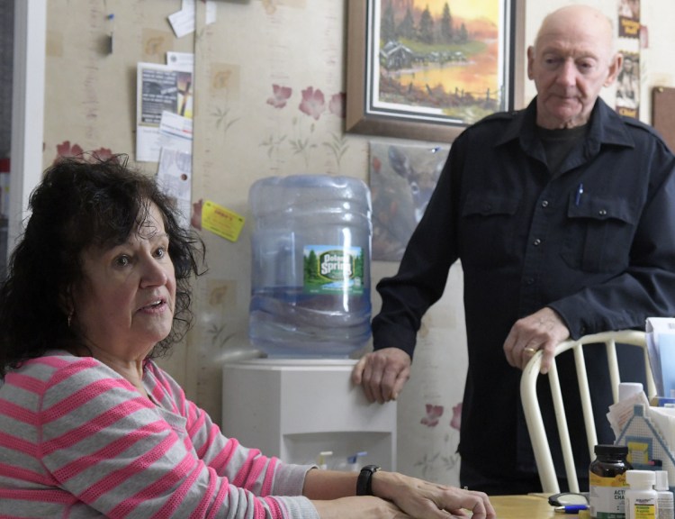 Gene and Cathy Burgess at their home in Belgrade on Friday. Homeowners around Belgrade's Cemetery Road, Routes 11 and 27 triangle seeing high levels of salt in their wells. DOT is currently providing bottled water to them while seeking a long-term solution.