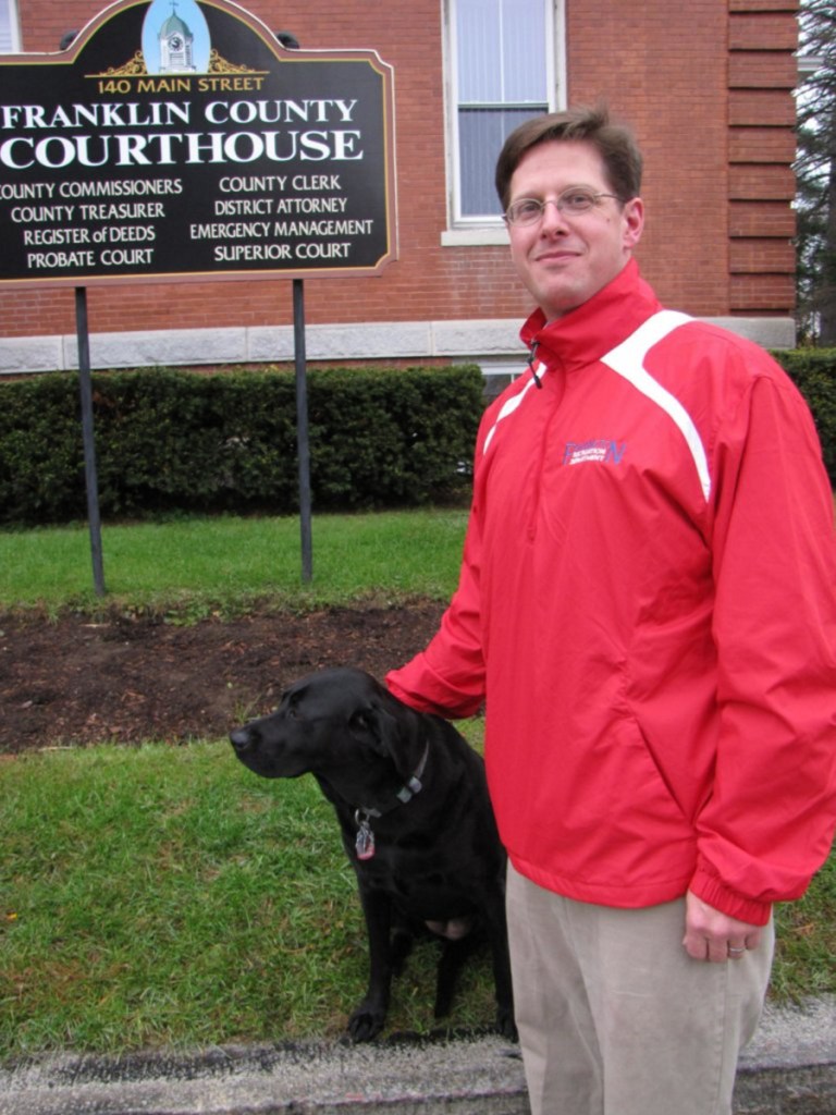 Andrew Robinson with his dog Buttercup in front of the Franklin County Courthouse.