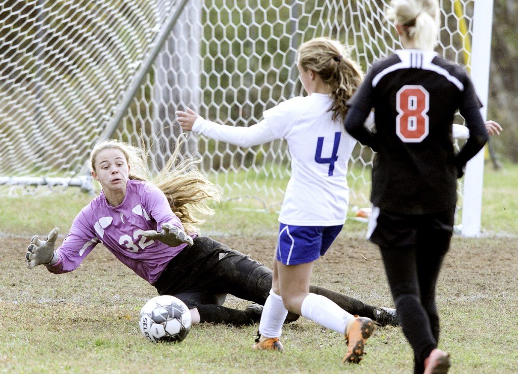 Lisbon goalie Sarah Haggerty jumps on a shot by Mt. Abram's Kaylee Knight during the second half of a Class C South quarterfinal game Wednesday in Lisbon. Haggerty made the save.