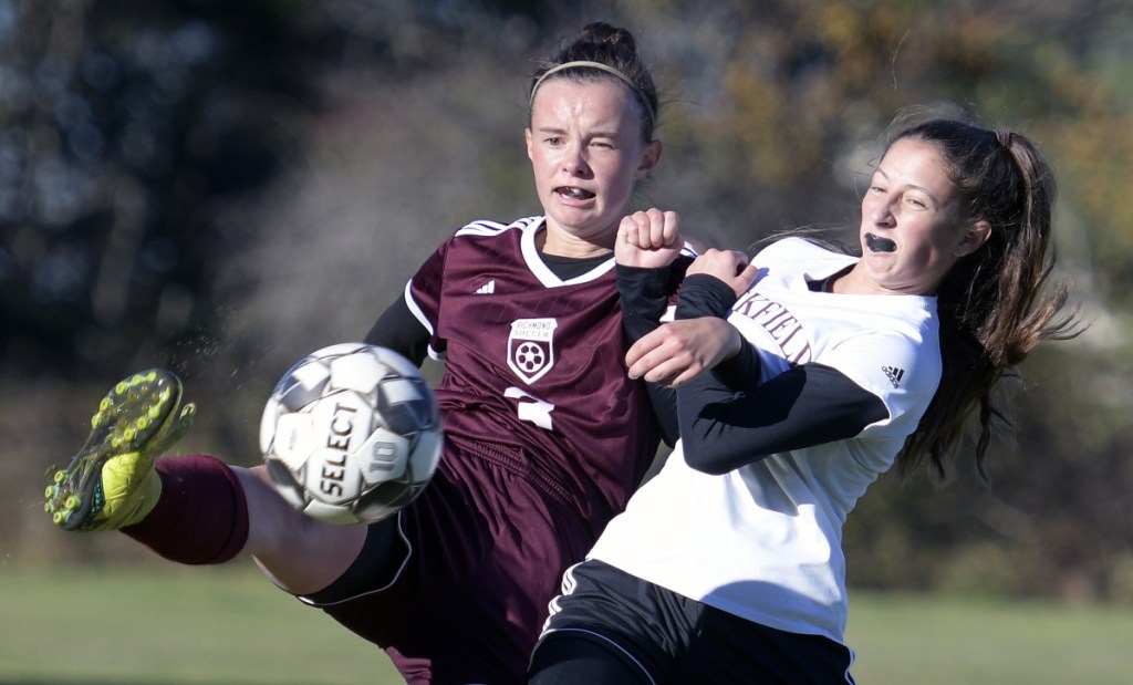 Richmond's Marie Wockenfuss, left, kicks a ball past Buckfield's Katy Henderson during a Class D South semifinal game Friday in Richmond.