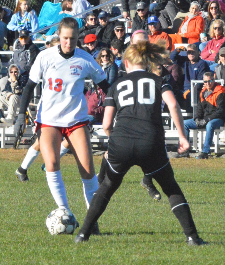 Messalonskee striker Anika Elias (13) prepares to make a move as Brunswick's Riley McAllaster (20) defends her during a Class A North semifinal game Friday in Brunswick.