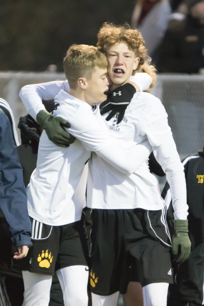 Maranacook players richard Down, right, and Aric Belanger celebrate after the Black Bears beat Hall-Dale in penalty kicks in a Class C South semifinal game Friday in Lewiston.