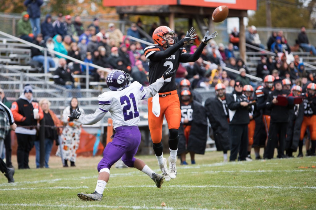 Winslow receiver Marek Widerynski catches a touchdown pass in front of Waterville defender Anthony Singh during a Class C North quarterfinal game Saturday in Winslow.