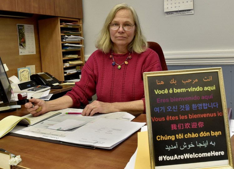 Franklin County Treasurer Pamela Prodon, at her desk at the Franklin County Courthouse in Farmington on Monday, displays a sign on her desk that states "You Are Welcome Here" in nine languages similar to the signs displayed by residents, including her in-laws, near the Tree of Life synagogue in Pittsburgh where a gunman killed 11 worshipers on Saturday.