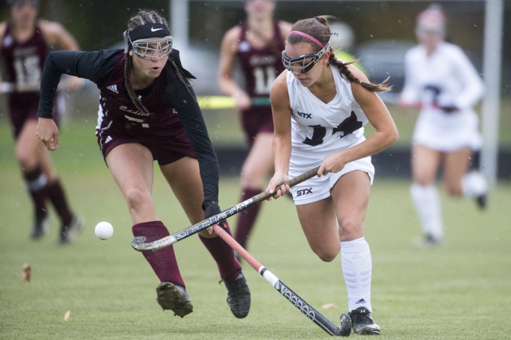 Skowhegan junior forward Alexis Michonski, right, tries to maintain possession of the ball as Edward Little's Emma Allen defends during a Class A North quarterfinal game Tuesday in Skowhegan.