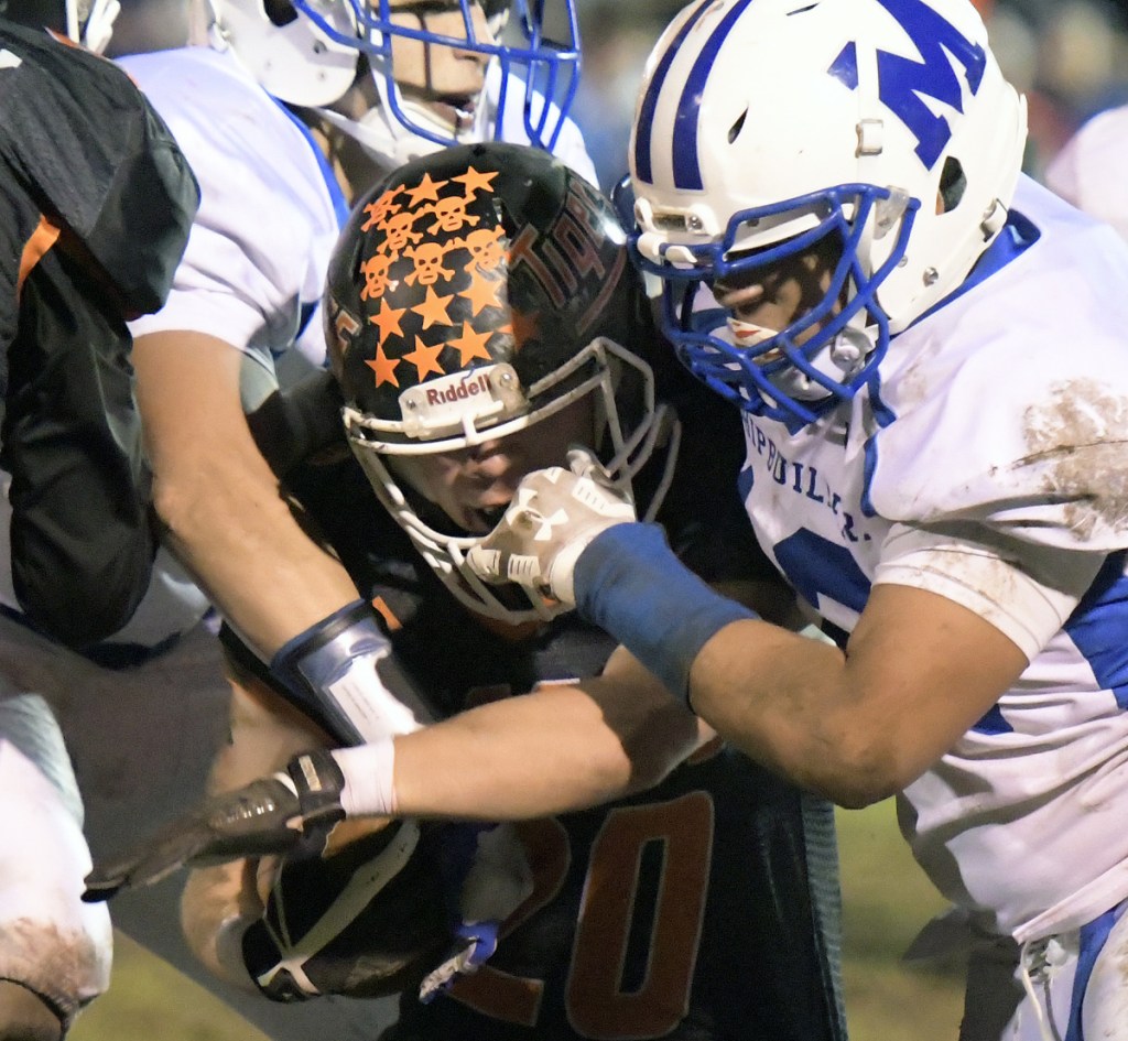 Gardiner's Nate Malinowski is tackled by the Morse defense during a Class C South quarterfinal game Friday in Gardiner.