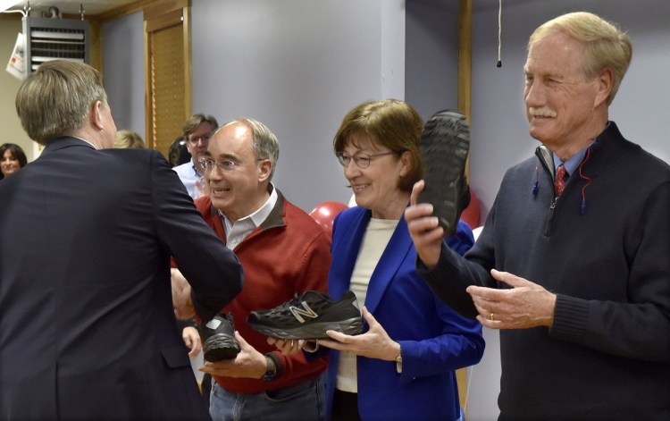 U.S. Sen. Angus King, I-Maine, at right, holds up a New Balance athletic shoe as Dave Wheeler, left, of the company hands U.S. Sen. Susan Collins, R-Maine, and U.S. Rep. Bruce Poliquin, R-2nd District, their own shoes Tuesday in Norridgewock. Both Collins and King said they oppose President Donald Trump's plan to issue an executive order revoking birthright citizenship for the children of noncitizens and unauthorized immigrants born in the U.S. Poliquin did not take a position on the order.
