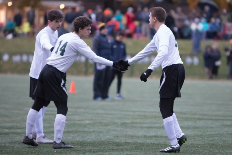 Photo by Jennifer Bechard
Temple's Noah Shepherd (14) shakes Ilija Ivkovic's hand after Ivkovic makes his penalty kick in the Class D South final against North Yarmouth Academy Wednesday.