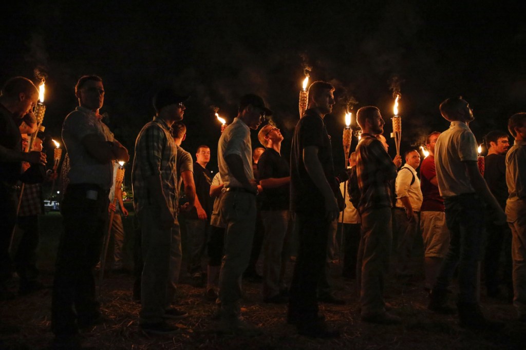 Multiple white nationalist groups march with torches through the University of Virginia campus in Charlottesville, Virginia, on Aug. 11, 2017. Four arrests have been made in connection with a white nationalist march and rally.