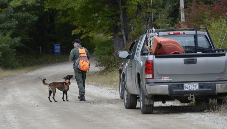Game Warden Jeremy Judd prepares to go out into the woods with a search dog Thursday to look for Kristin Westra of North Yarmouth who has been missing since Sunday night.