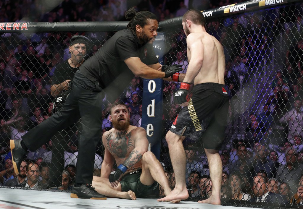 Khabib Nurmagomedov, right, is held back by referee Herb Dean after fighting Conor McGregor during a lightweight title mixed martial arts bout at UFC 229 in Las Vegas on Saturday. Nurmagomedov won the fight by submission during the fourth round to retain the title.