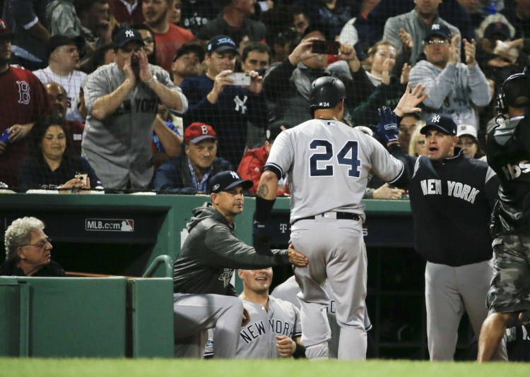 Gary Sanchez is greeted at the New York Yankees dugout after the first of his two home runs against the Boston Red Sox Saturday night at Fenway Park. (AP Photo/Elise Amendola)