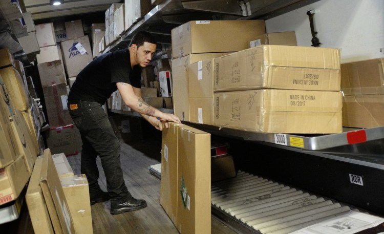 A UPS employee preps a truck at a facility in New York. Heading into the holiday season, the job market is the tightest it has been in nearly five decades. UPS plans to hold nearly 170 job fairs around the country on Oct. 19, hoping to fill out its ranks.