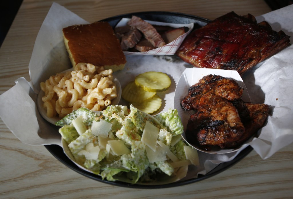 This combo plate featured slow-smoked chicken, brisket and ribs with cornbread, mac and cheese and Caesar salad.
