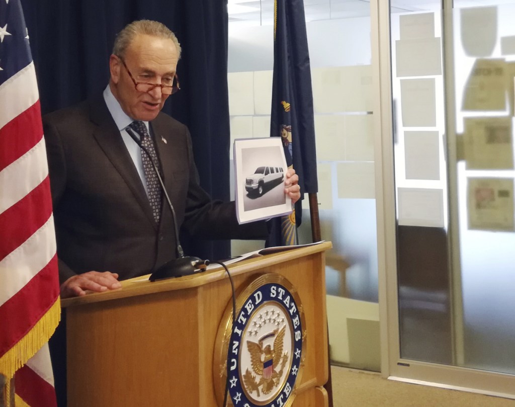 Sen. Chuck Schumer, D-NY, holds a photo of a stretch limousine during a news conference in New York in which he pointed to glaring gaps in safety data that he says exist because federal officials have not done enough to investigate limo wrecks. (Associated Press/Julie Walker)