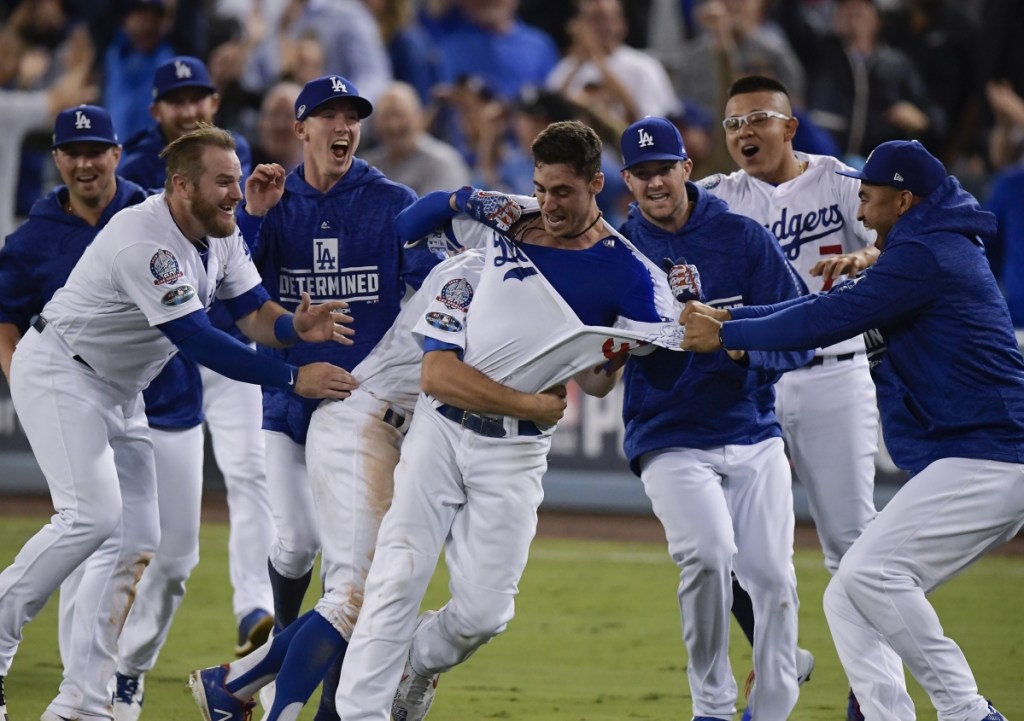 Cody Bellinger celebrates after hitting a walk-off hit during the 13th inning of Game 4 Tuesday night in Los Angeles. The Dodgers won 2-1 to tie the series with Milwaukee at 2-2. (AP Photo/Mark J. Terrill)