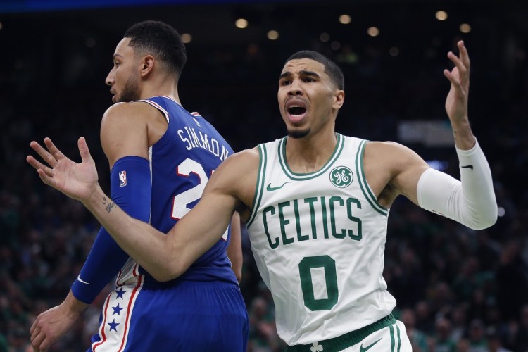 Boston's Jayson Tatum pleads for a call against Philadelphia's Ben Simmons during the first half of Tuesday's season-opening game in Boston.
