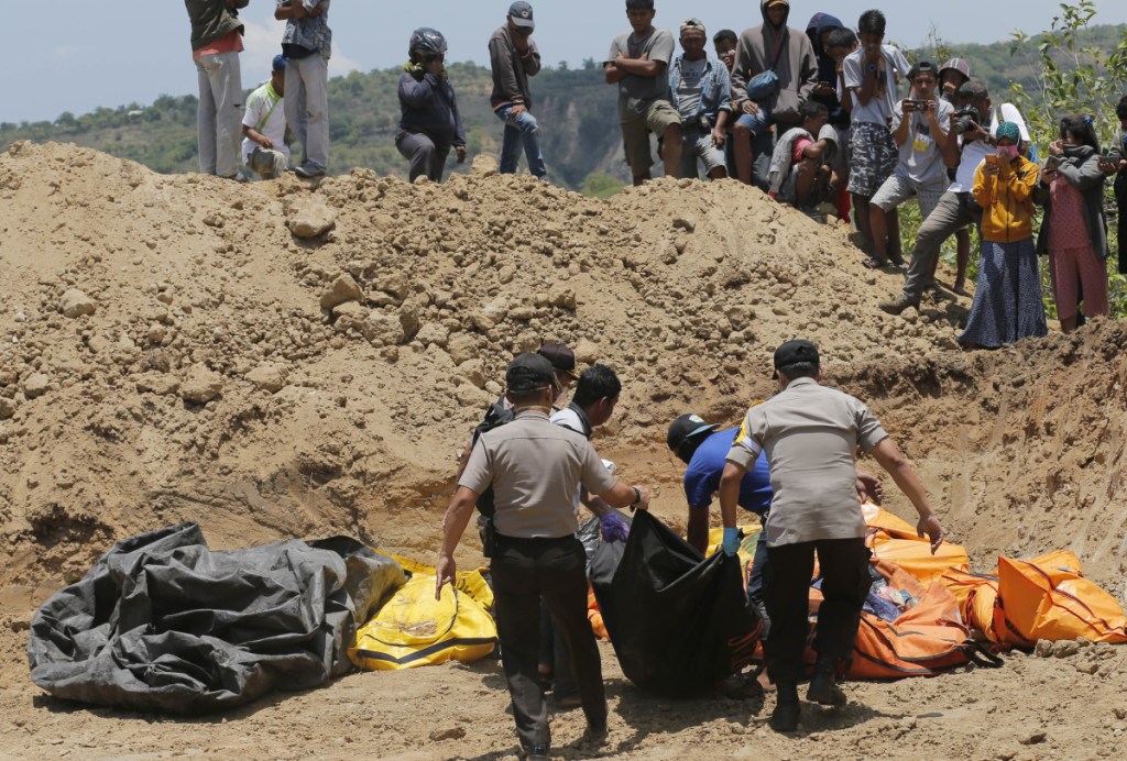 Rescue teams carry the bodies of victims to a mass grave following the major earthquake and tsunami in Palu, Central Sulawesi, Indonesia.
Associated Press/Tatan SyuflanaFile