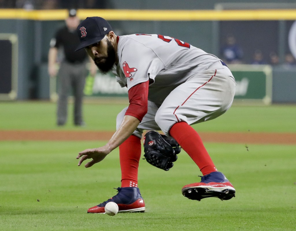 Boston pitcher David Price fields a ball hit by the Astros' Jake Marisnick during the fifth inning in Game 5 of the ALCS Thursday in Houston. Marisnick was out at first. (AP Photo/Frank Franklin II)