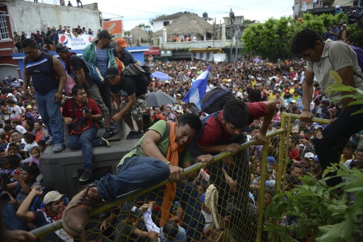 Thousands of Honduran migrants rush across the border toward Mexico, in Tecun Uman, Guatemala, on Friday.