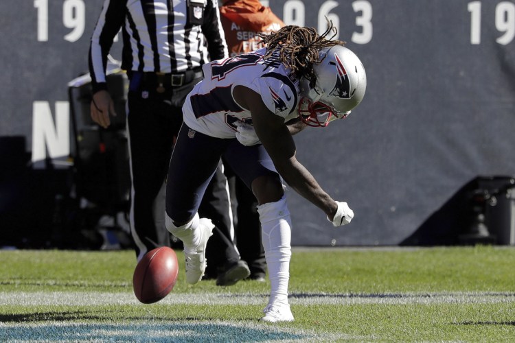 New England's Cordarrelle Patterson spikes the ball to celebrate after return a kickoff 95 yards for a touchdown against the Bears on Sunday in Chicago.
