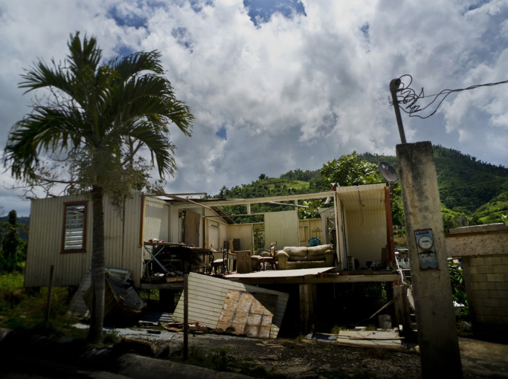 A home abandoned after Hurricane Maria hit a year ago is still full of furniture Sept. 8 in Morovis, Puerto Rico. The U.S. territory has been in a recession for 12 years and has over $70 billion in public debt.