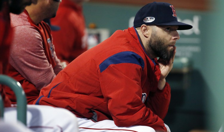 Boston's Dustin Pedroia watches from the dugout in the late innings of Game 2 of the AL Division Series against the Yankees on Oct. 6. Pedroia only played in three games this season, but teammates respect his veteran leadership.