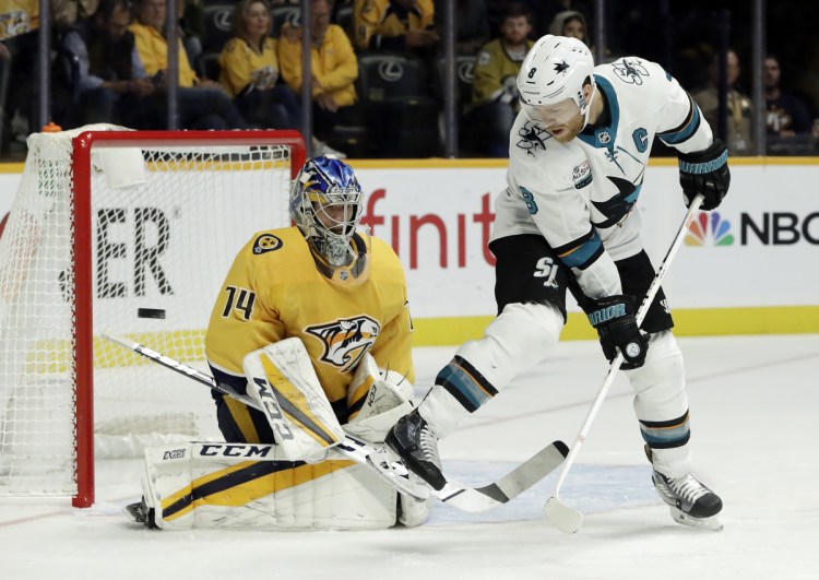 San Jose's Joe Pavelski tries to deflect a shot as it goes wide of the net on Nashville goaltender Juuse Saros in the first period Tuesday night at Nashville, Tenn.