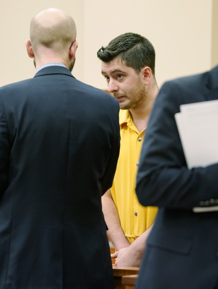 Joseph Lewis, 27, charged with felony aggravated assault, stands with attorney Stephen Shea during his initial court appearance Wednesday in Portland.