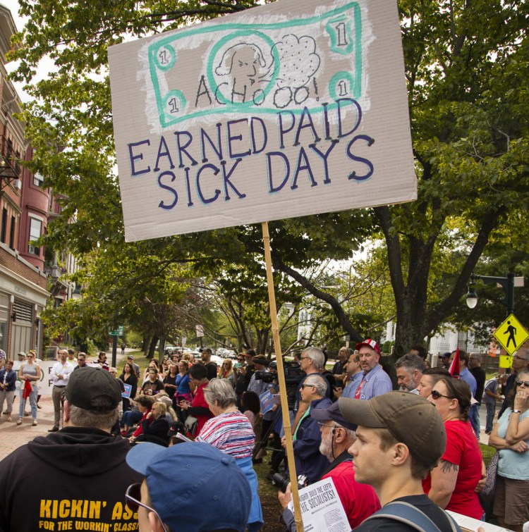 People rally in Longfellow Square last year during the launch of a campaign to require employers in Portland to provide earned sick days.