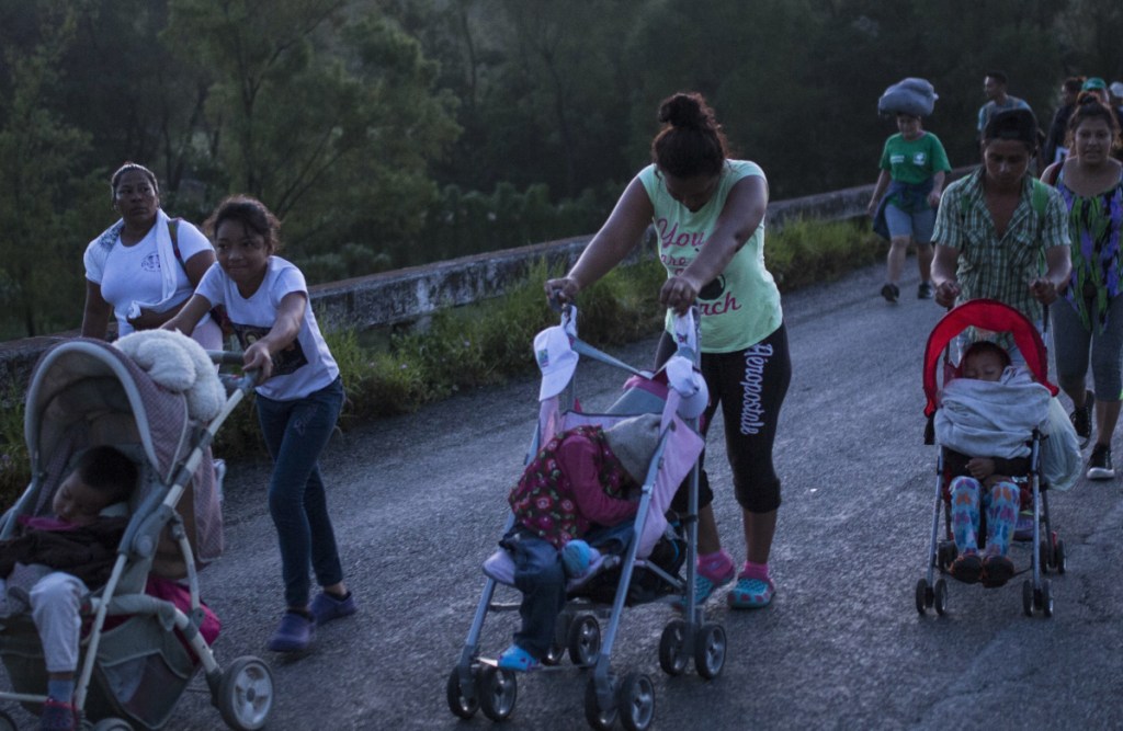 Starting out before dawn, Central American migrants make their way to Pijijiapan, Mexico, on Thursday.