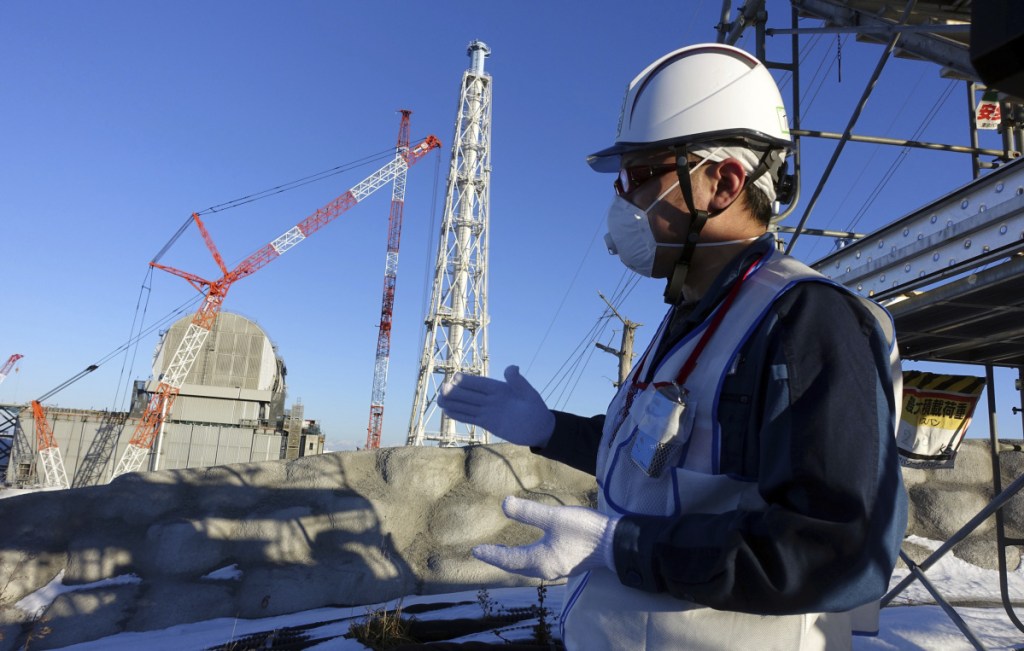 A Tokyo Electric Power official discusses the Fukushima Dai-ichi nuclear power plant last January.