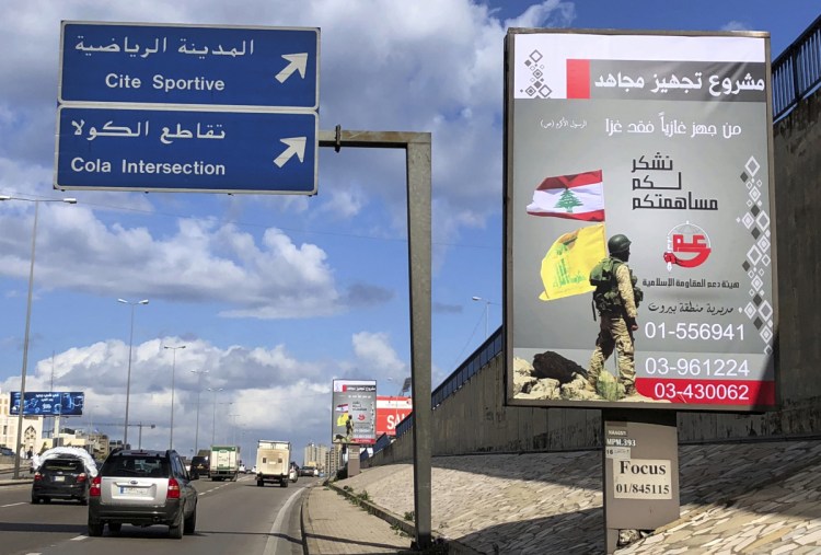 Billboards from Hezbollah's committee for the support of the Islamic resistance, that shows a Hezbollah fighter while holding the group's yellow banner and the Lebanon's national flag, are displayed on the Beirut airport highway in January.
