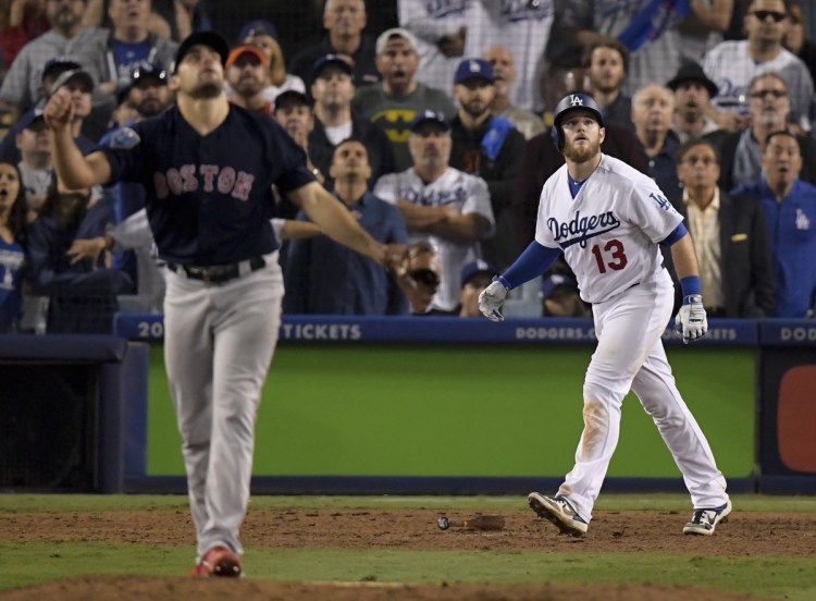 Los Angeles's Max Muncy watches his walk off home run off Boston pitcher Nathan Eovaldi during the 18th inning in Game 3 of the World Series on Saturday morning in Los Angeles.