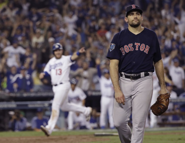 Max Muncy scores on a throwing error by Boston pitcher Nathan Eovaldi during the 13th inning in Game 3 of the World Series on Friday in Los Angeles. Eovaldi had a gutsy six-inning performance before allowing a Muncy home run in the 18th inning.