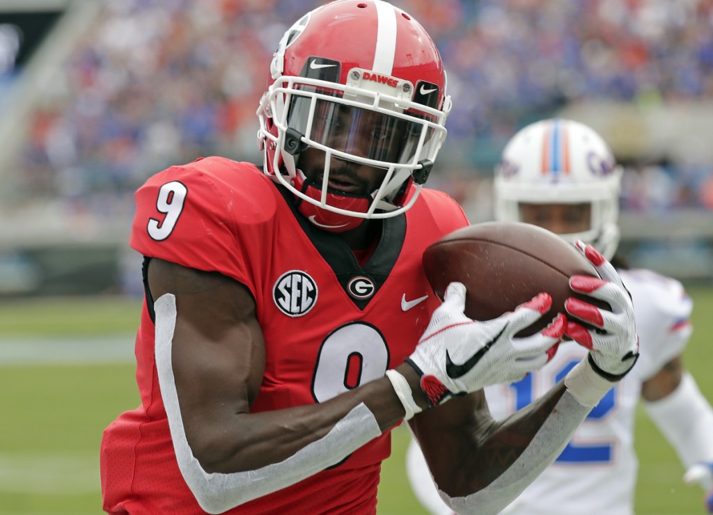 Georgia wide receiver Jeremiah Holloman catches a 16-yard touchdown pass in front of Florida defensive back C.J. McWilliams during the first half of the Bulldogs' 36-17 win at Jacksonville, Florida on Saturday.