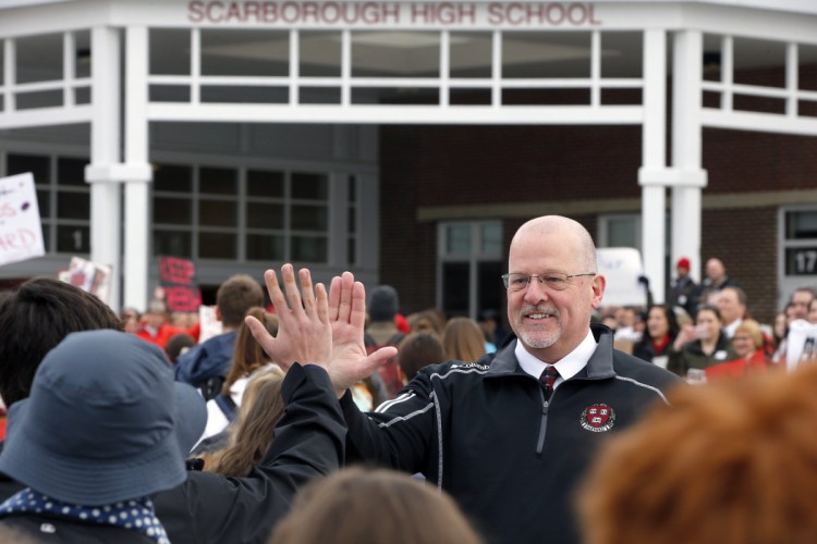 Scarborough High School Principal David Creech, who resigned suddenly in February and later said he was forced to leave, greets arriving students this year.