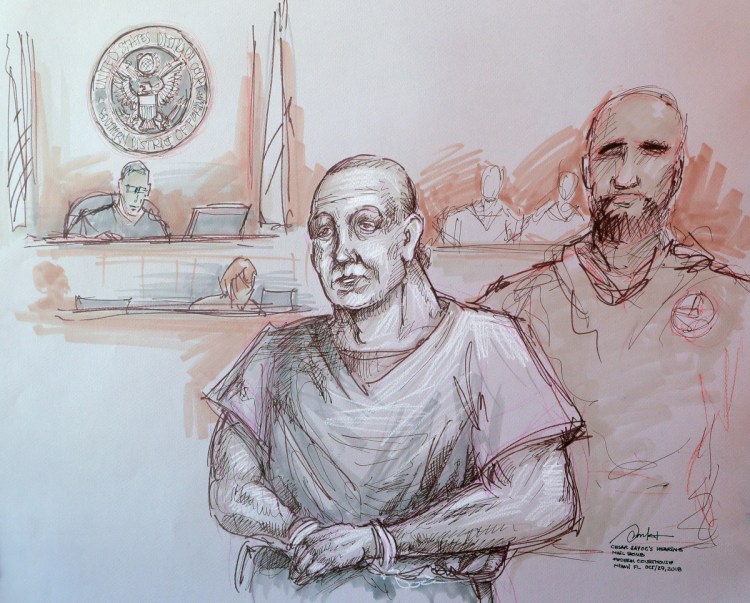 In this courtroom sketch, Cesar Sayoc, left, appears in federal court on Monday in Miami. Sayoc is accused of sending pipe bombs to prominent Democrats around the country. A judge will hold a hearing Friday on whether Sayoc can be released on bail.