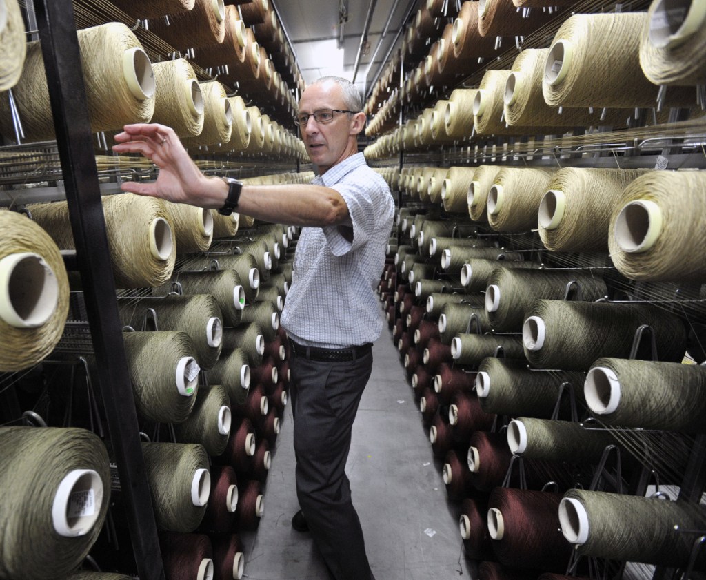 Johan Moulin, president at Flemish Master Weavers in Sanford, looks over the spools on creels at Flemish Master Weavers in Sanford in 2016.