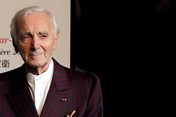 French singer Charles Aznavour poses for photographers on Oct.20, 2017, as he arrives to attend the 9th Lumiere festival Award ceremony, in Lyon, central France. Aznavour, whose performing career spanned eight decades, has died. He was 94. 