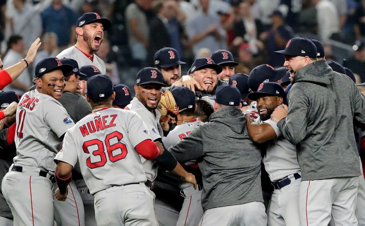 The Red Sox celebrate after beating the Yankees 4-3 and clinching the American League Division Series on Tuesday night in New York.