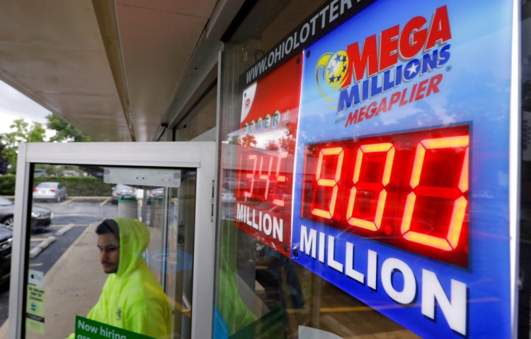 The Mega Millions jackpot is displayed as a customer leaves the Corner Market, Wednesday, in Lyndhurst, Ohio. The next drawing will be Friday. 