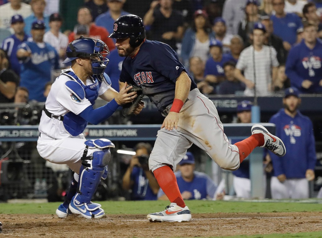 Ian Kinsler is tagged out at the plate by Dodgers catcher Austin Barnes while trying to score the go-ahead run on a fly ball by Eduardo Nunez in the 10th inning.
