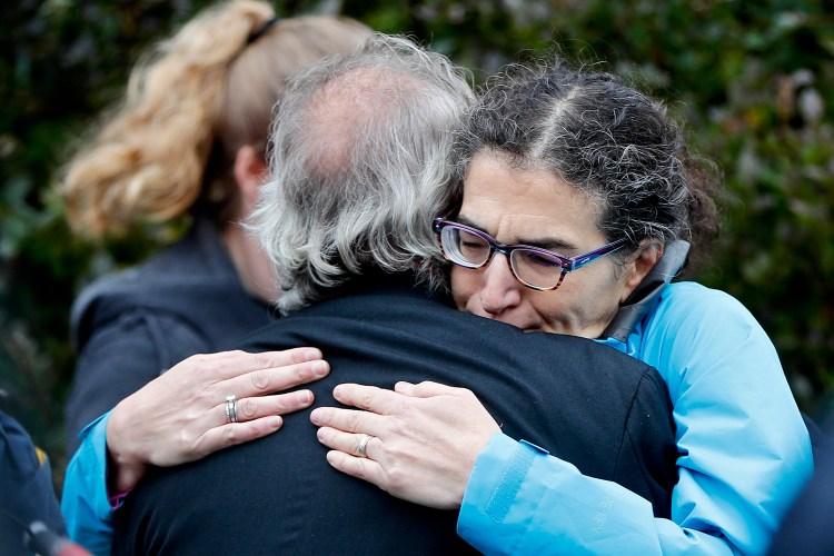 People embrace along the street in the Squirrel Hill neighborhood of Pittsburgh where a shooter opened fire during services at the Tree of Life Synagogue on Saturday.