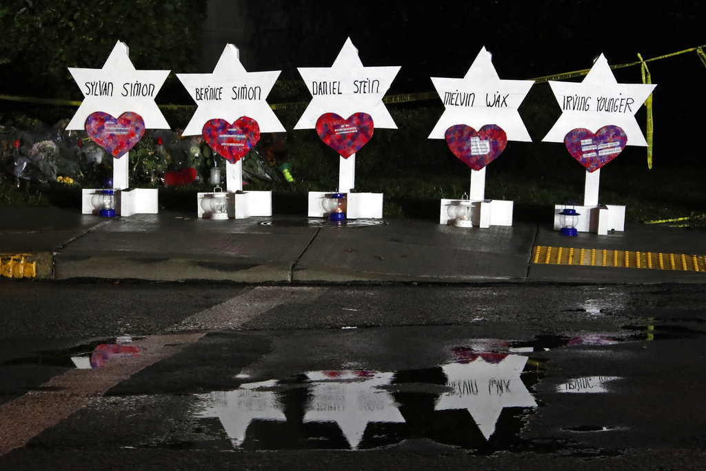 This photo shows some of Stars of David with names of those killed at the Tree of Life Synagogue in Pittsburgh in Saturday's shooting, at a memorial outside the synagogue, Sunday, Oct. 28, 2018. (AP Photo/Gene J. Puskar)
